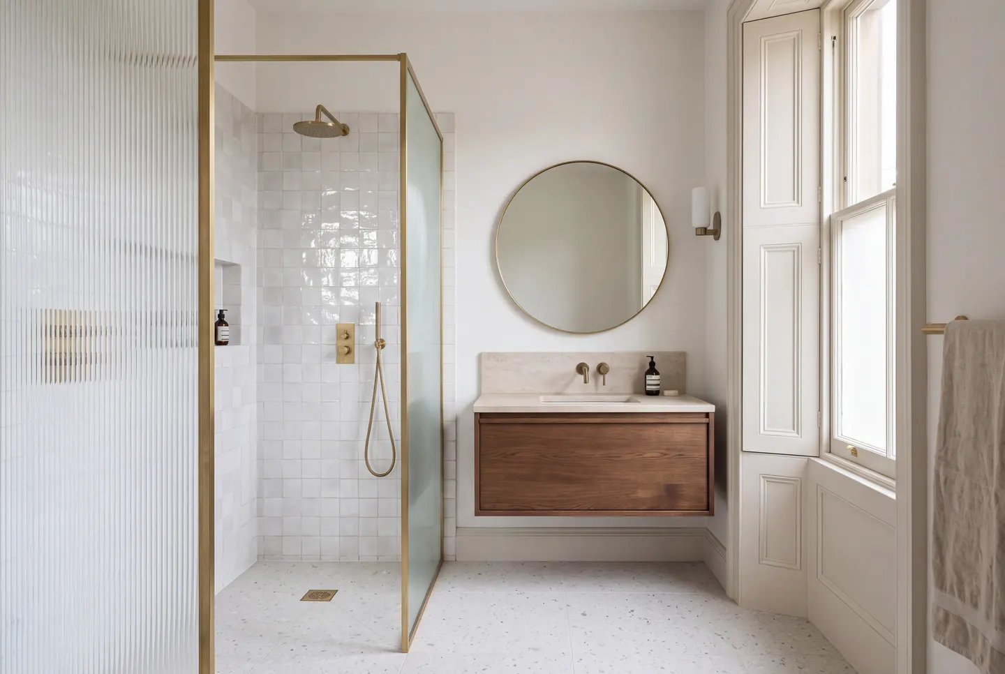Illustration of a shower room with a fluted glass screen, a terrazzo floor and the original sash window